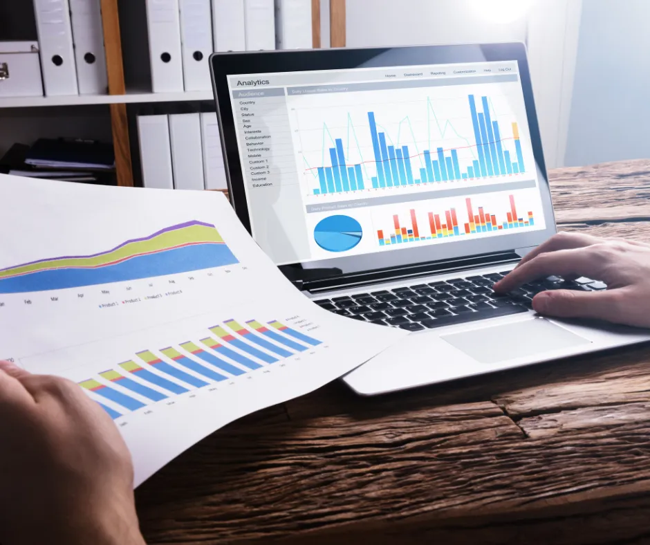 Discussing savings strategy on a laptop chart